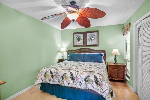 a bedroom with a bed with a ceiling fan at Midnight Cove II 213F in Siesta Key