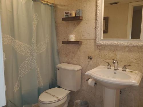 a bathroom with a toilet and a sink at Midnight Cove II 212F in Siesta Key