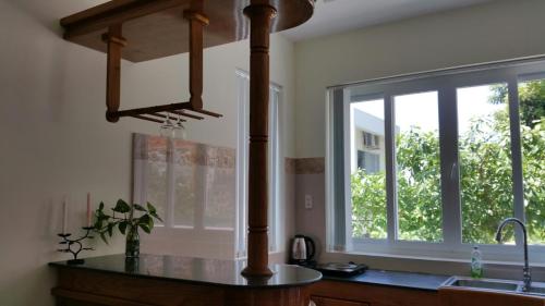 une cuisine avec un évier, une fenêtre et un comptoir dans l'établissement Mango Tree, à Vung Tau