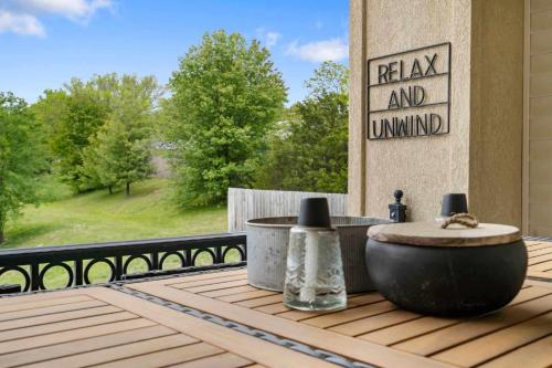 a wooden table with a bowl on a deck at Kings Hideaway - Near DT in Branson
