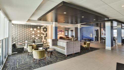 a lobby of a hotel with chairs and tables at Holiday Inn Express & Suites - Nashville MetroCenter Downtown by IHG in Nashville