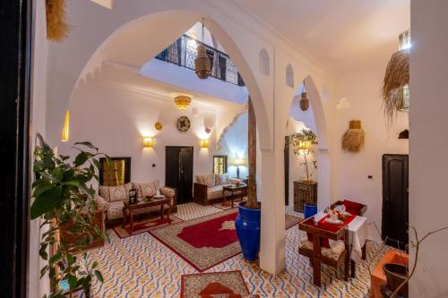 un soggiorno con un ingresso ad arco di Riad des remparts Marrakech a Marrakech