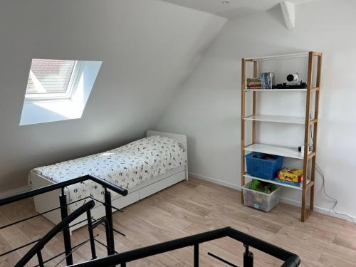 a bedroom with a bed and a book shelf at Maison idéale famille, 6 pers - Disney 15 min in Quincy-Voisins
