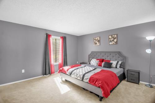 a bedroom with a bed with a red blanket at Modern 3BR 2 bathroom Near High Point University & Market Sleeps 6 in High Point