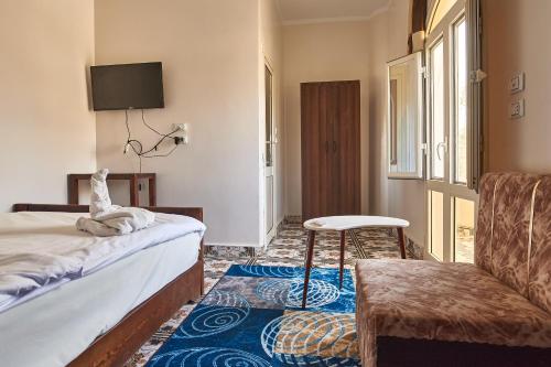 Ένα ή περισσότερα κρεβάτια σε δωμάτιο στο Sunset Guest house