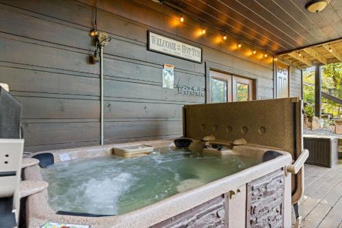 a large jacuzzi tub sitting on a patio at 1 Great Mountain View by American Patriot Getaways in Park Settlement