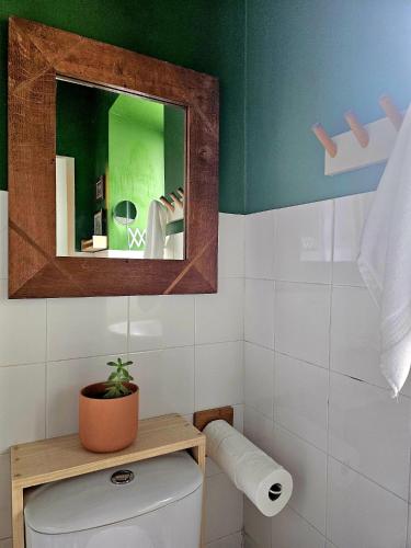 a bathroom with a mirror and a toilet in it at Marina Lounge Home in Ponta Delgada