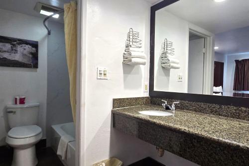 a bathroom with a sink and a toilet and a mirror at Century Motel Buena Park Anaheim CA 91 in Buena Park