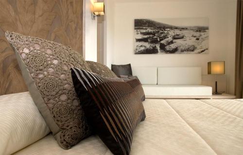 a bedroom with a bed with pillows on it at Can Miquel in L'Escala
