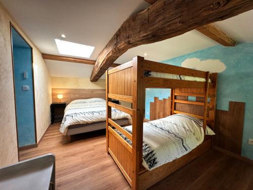 a bedroom with two bunk beds in a house at Chez Delphine in Doizieux