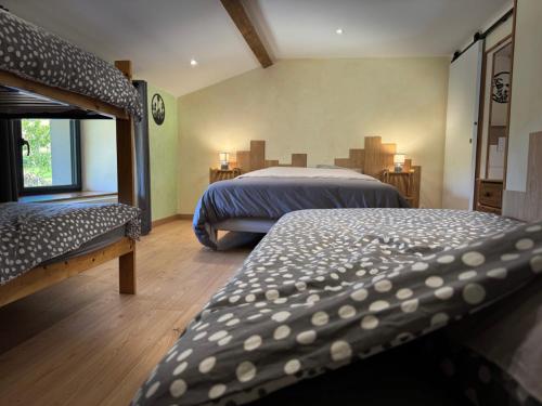 a bedroom with two beds and a window at Chez Delphine in Doizieux