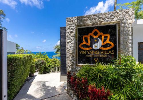 a sign for myung villas with the ocean in the background at Villa Yin-Noi, Private Oceanfront Villa, Kamala Beach in Kamala Beach