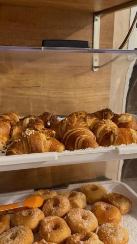 a bunch of pastries on trays in a bakery at Chiaia Suites in Naples