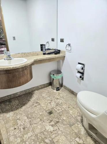 a bathroom with a toilet and a sink at master bedroom in Medellín