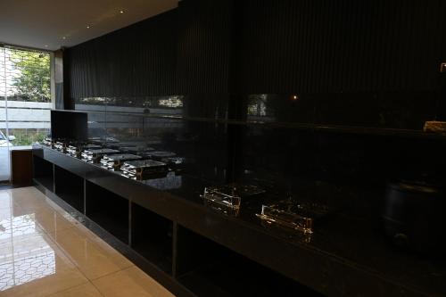 a kitchen with a black counter with a stove at Good One Suites in Bengaluru