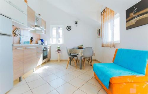 a living room with a blue couch and a table at Lovely Apartment In Omis With Wifi in Tice