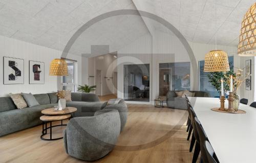 a living room with a couch and a table at Beautiful Home In Idestrup With Sauna in Stovby