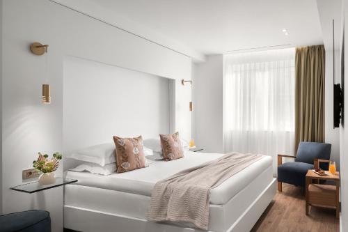 Ένα ή περισσότερα κρεβάτια σε δωμάτιο στο White Rose Athens Residence