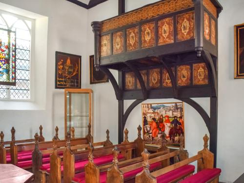 an altar in a church with a large wooden pulpit at The Knights Apartment, Eastbridge Hospital in Canterbury