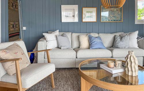 a living room with a couch and a coffee table at Cozy Home In Førde I Hordaland in Erve