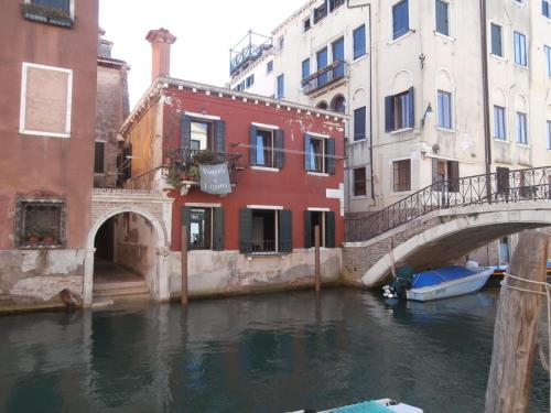 a bridge over a canal in a city with buildings at Cocoloco in Venice