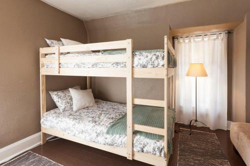 a bedroom with two bunk beds and a lamp at Lucky 30 Day in Hood River