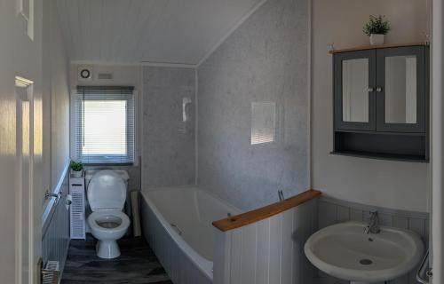 Maltby le MarshにあるWren Lodgeの浴槽、トイレ、洗面台を備えたバスルーム