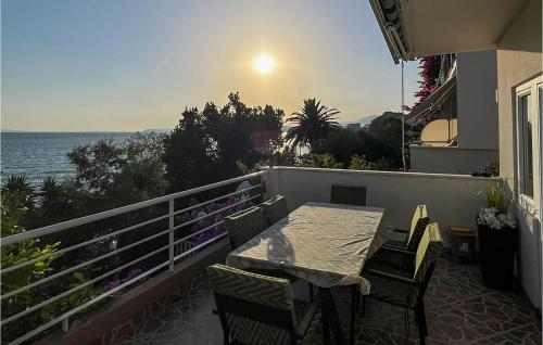 ein Balkon mit Tisch und Stühlen und dem Meer in der Unterkunft 2 Bedroom Stunning Apartment In Podstrana in Podstrana