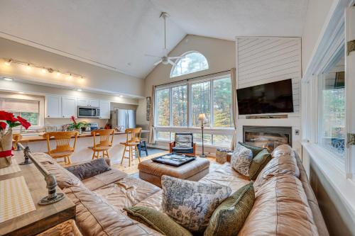 a large living room with a couch and a fireplace at White Mountains Home with Hot Tub - Walk to Town! in North Conway