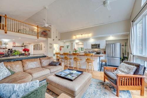 a living room with a couch and a kitchen at White Mountains Home with Hot Tub - Walk to Town! in North Conway