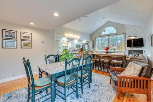 a kitchen and living room with a table and chairs at White Mountains Home with Hot Tub - Walk to Town! in North Conway