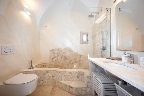 a bathroom with a tub and a toilet and a sink at Villa Lighthouse 6 - Porto Cervo in Porto Cervo