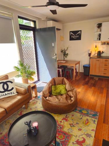 a living room with a couch and a table at Quiet, Peaceful Northcote Unit in Melbourne