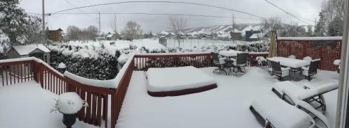 a yard covered in snow with tables and chairs at 5 Bedrooms, Mountain Views, Steps from Blue Mountain Village, Hot Tub, BBQ in Blue Mountains