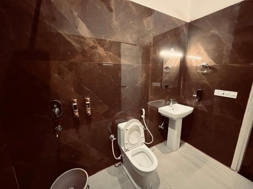 a bathroom with a toilet and a sink at Sariska Bliss Farm, #2-BHK, #Private Pool & Garden in Alwar