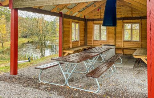 a picnic table and two benches in a cabin at 1 Bedroom Lovely Home In Våxtorp in Jonstorp