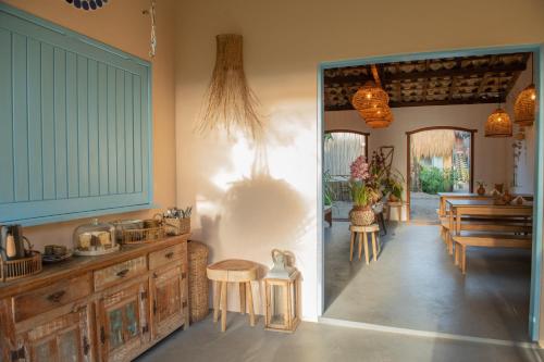 a kitchen with wooden cabinets and a table and chairs at Pousada Caraíva in Caraíva