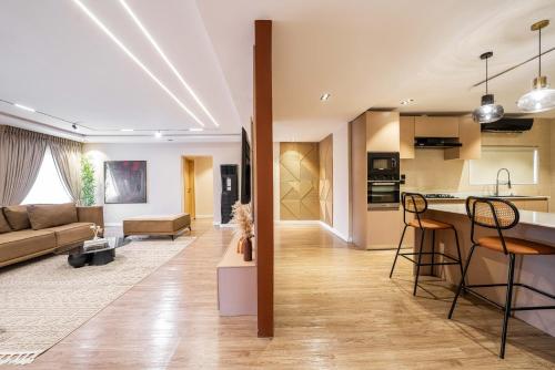 a living room and kitchen with a couch and a table at George Residence SDA Court, Banana Island, Ikoyi in Lagos