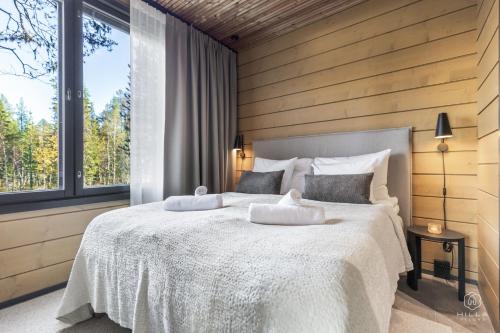 Postel nebo postele na pokoji v ubytování Levin Lyhty Beatrice by Hilla Villas