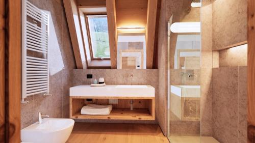 a bathroom with a sink and a toilet and a mirror at Funivia Bormio Active Hotel - Adults Only in Bormio