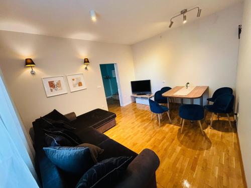 a living room with a couch and a table at Apartament R48 in Dąbrowa Tarnowska