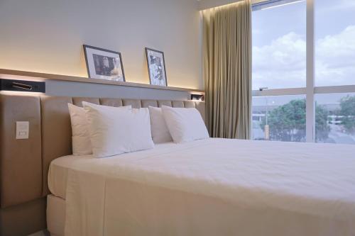 Postel nebo postele na pokoji v ubytování Transamerica Executive Belém Aeroporto