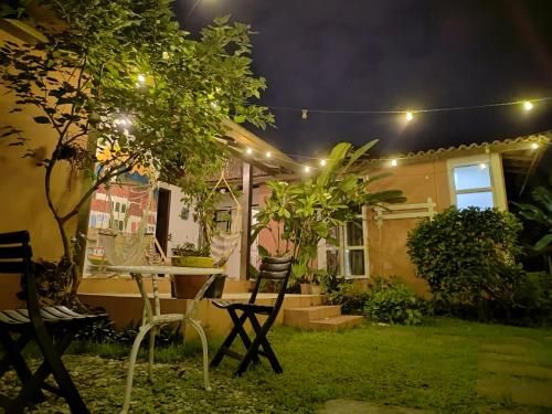 a table and chairs in a yard at night at Pousada Lira Praieira Paraty in Paraty