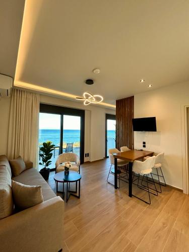 a living room with a couch and a table at Kyllini Seaside Apartments & Rooms in Kyllini