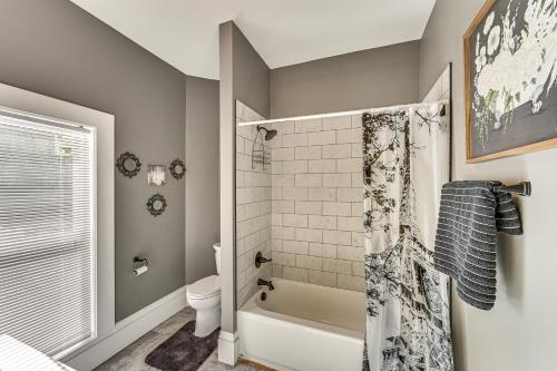 a bathroom with a tub and a toilet and a shower at 6 Mi to Notre Dame Family Retreat with Deck and Yard in Mishawaka