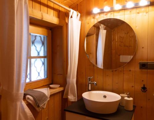 a bathroom with a sink and a mirror at Bauernhaus Spathen in Santa Valburga St. Walburg