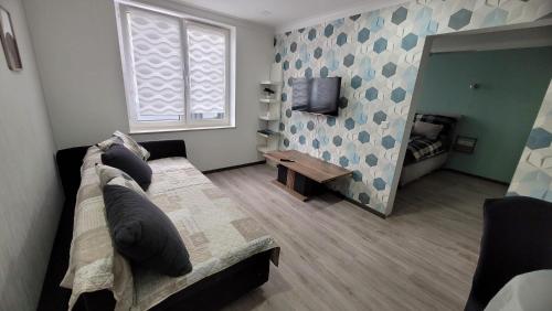 a living room with a couch and a television at Ferienwohnung Nordstern in Papenburg