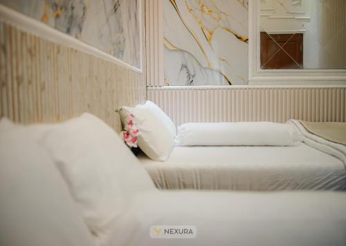 Un ou plusieurs lits dans un hébergement de l'établissement Grand House Nexura Collection