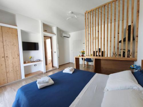 a bedroom with a large blue bed and a desk at Pietra Bianca in Cutrofiano