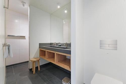 a bathroom with a sink and a mirror at Seaside Family Villa 6p - Direct bij het Strand - Villa 24 in Ouddorp